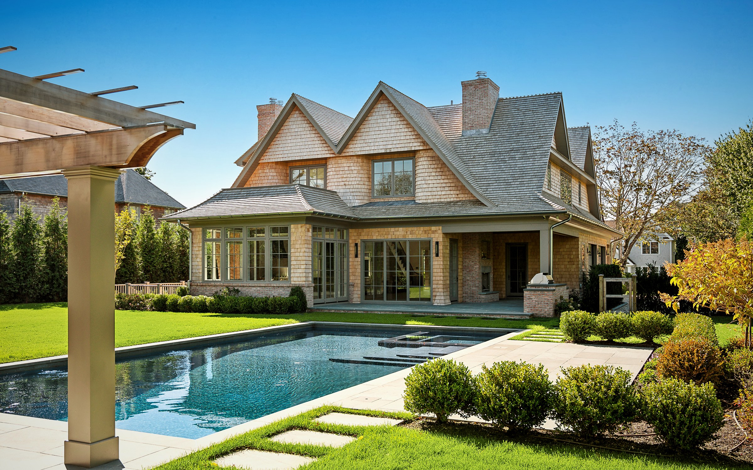 Custom shingle-style coastal home with pool, built by Dovetail Design + Build